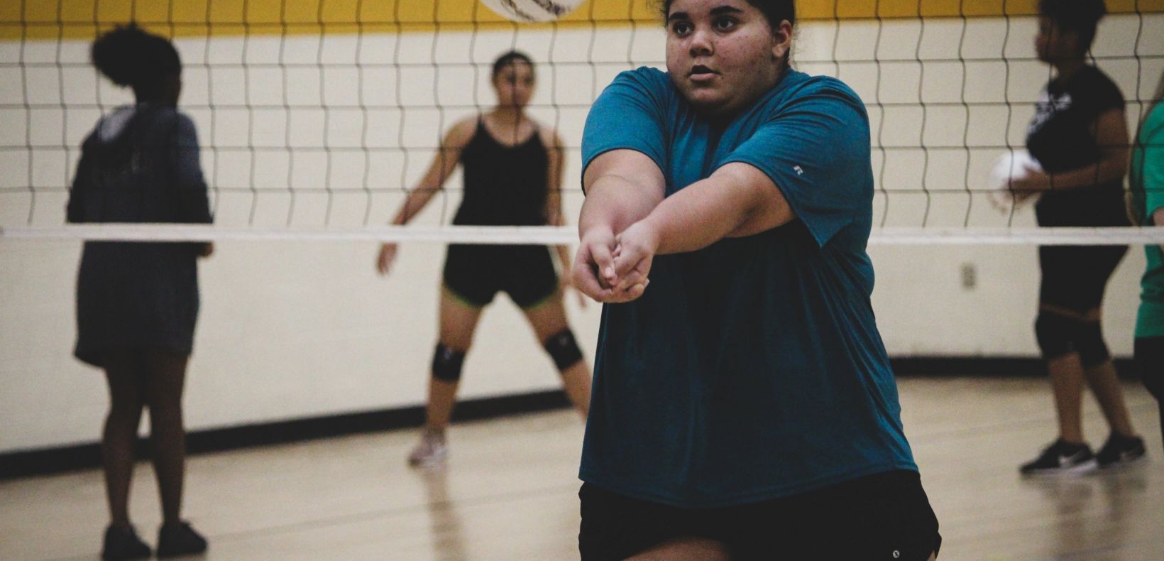 girl bumping a volleyball