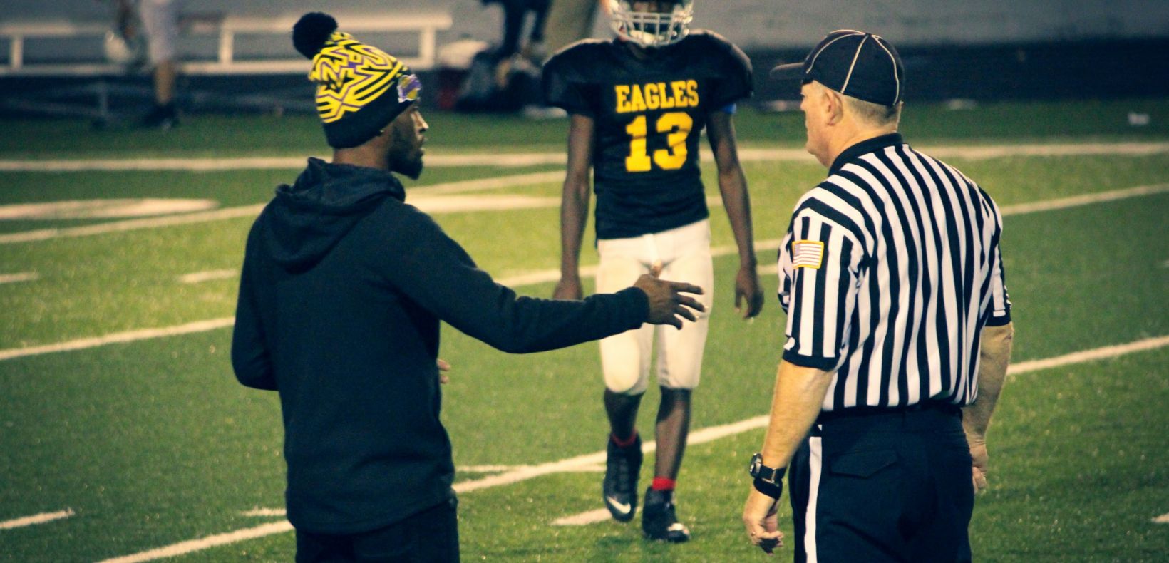 coach talking with a referee
