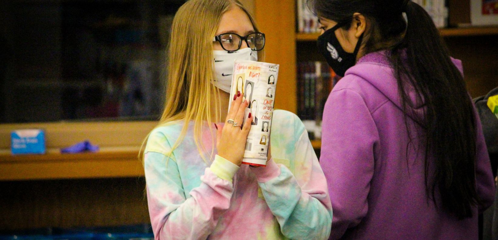 student holding a book