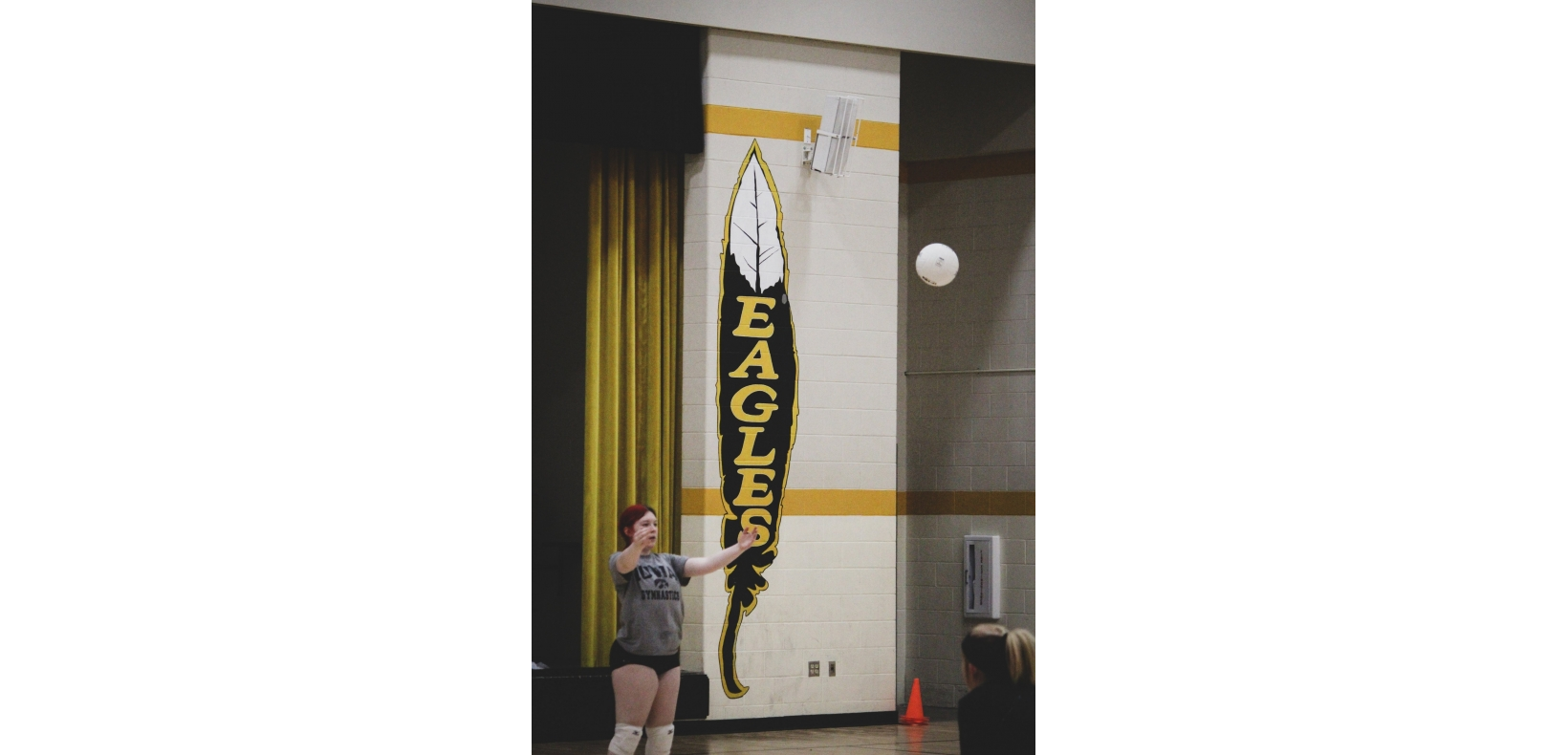 girl serving a volleyball