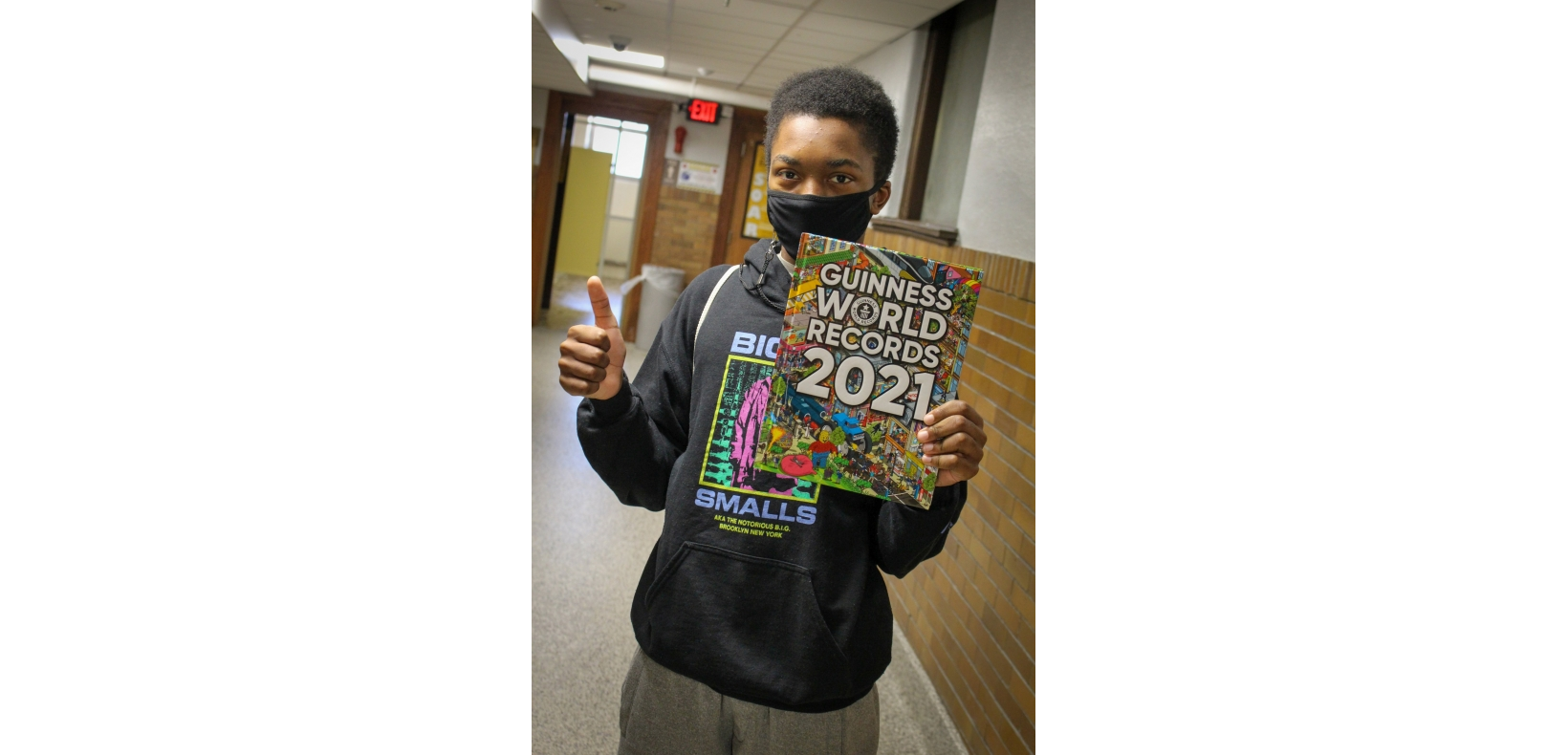 student holding a book up